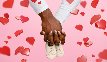 A couple holds baby boots together with their hands against a yellow background. The scene shows hearts around them, celebrating the arrival of a new baby in their home.