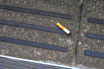 Fototapeta premium Cigarette butt on the pavement.