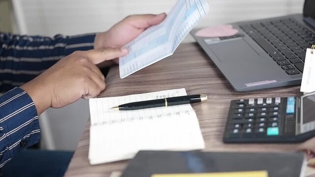 Viewing Bank Account Book in front of laptop, Account Statement, Money Number, Check Payment and Income, Financial Documents, Pay Slip, Cash Balance, Investment, Paper Page, Business