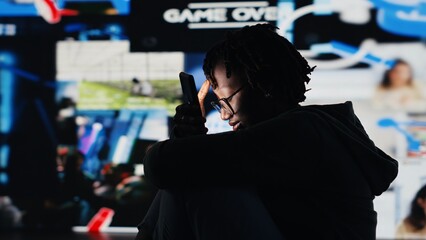 Person addicted to smartphone, looking at internet video channels, isolated over digital backdrop. African american woman enjoying metaverse video content on device, 360 degrees rotation, camera B