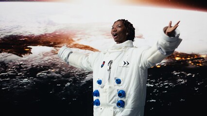 Ecstatic astronaut rotating 360 degrees in front of planet glowing horizon with arms open wide. Cosmonaut excited by outer space, concept of planetary discovery and human wonder, camera A © DC Studio