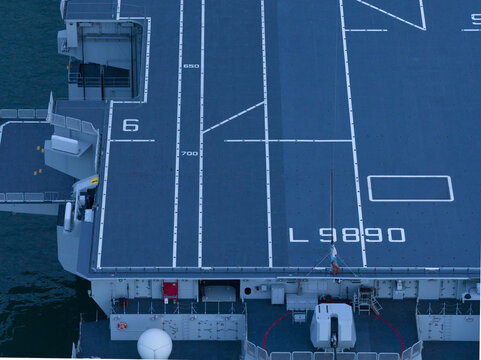 Aerial view of the flight deck of the LHD Trieste, a symphony of blue and white in sharp geometric contrast, Trieste, Italy.