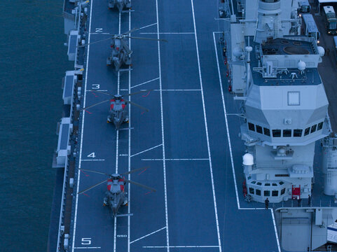 Aerial view of helicopters poised on the flight deck of The LHD Trieste, a symphony of steel and naval aviation, Trieste, Italy.