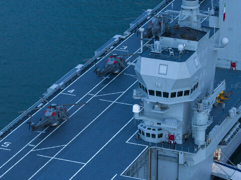 Aerial view of helicopters on the deck of the LHD Trieste, a symphony of steel and sea in the crisp, blue atmosphere, Trieste, Italy.