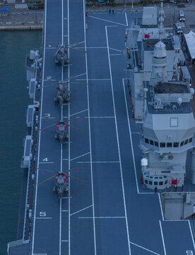 Aerial view of the LHD Trieste's flight deck displaying helicopters, a symphony of naval power and precision engineering against the backdrop of the Adriatic Sea, Trieste, Italy.