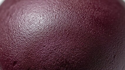 A close-up view of a textured purple fruit showing its surface details