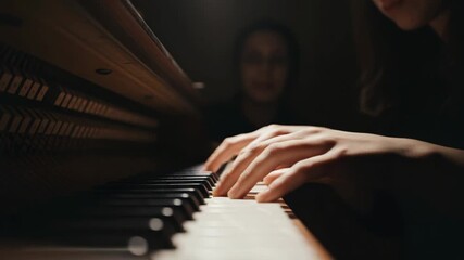 Female adult hands press the keys of a harpsichord, illuminated by a warm spotlight. This intimate scene captures the dedication of a musician performing classical music