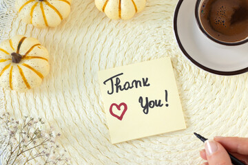Thank you handwritten note with coffee and pumpkin on vintage background. Top view. The concept of gratitude, appreciation, and thanksgiving.