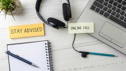 Headset and notebook on a desk preparing for an online call