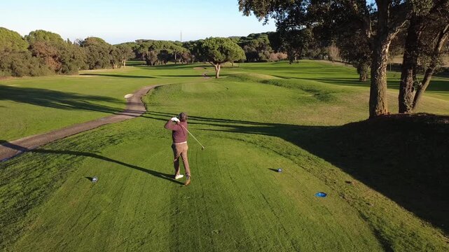 Golfer Hitting Driver Tee Shot on a sunny day from above