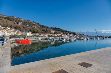 Baska harbor with red tourist submarine and boats