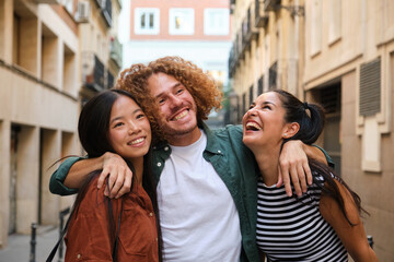 Group of young multi ethnic friends having fun together in the city, smiling and laughing