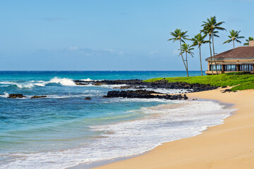 2021-10-19 A SANDY BEACH WITH NICE BLUE WATER AND WAVES COMING A SHORE WITH SOME ROCKS EXPOSED ON KAUAI HAWAII