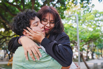 Fototapeta premium Young couple embracing with affection in park