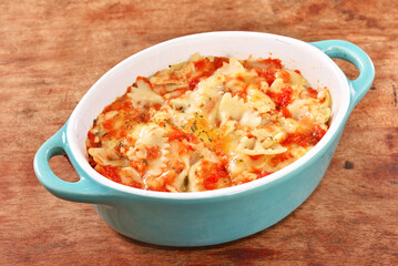 Margherita farfalle gratin in a baking dish . 