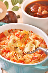 Margherita farfalle gratin in a baking dish . 