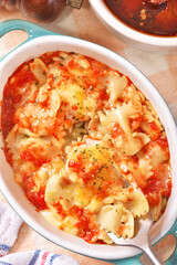 Margherita farfalle gratin in a baking dish . 