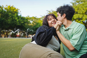 Fototapeta premium Couple sharing an intimate moment in a park