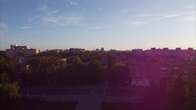 A drone ascends over Tver, revealing quiet early-morning city streets, buildings, and roads. The city appears empty and peaceful at dawn.