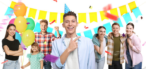 Obraz premium Birthday boy celebrating with his family and friends on white background. Surprise party with confetti and bunting flags