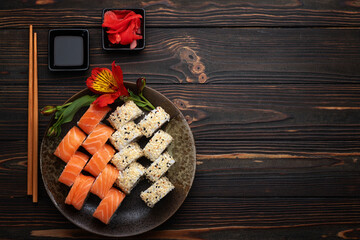 Sushi rolls assortment wooden background