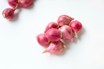 Red shallots on white background.