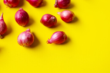 Red shallots on yellow background.