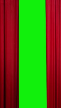 Vertical elegant red curtain opening to reveal green screen background with luxurious fabric motion, creating a cinematic stage effect perfect for transitions, video intros, theater and performance.