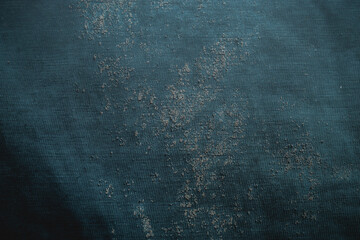 Teal green fabric texture with dried cement stains