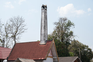 Acrematorium chimney in local temple in Chiang Rai province of Thailand. Crematory or cremation center is a venue for the cremation of the dead.