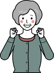 正面向き。ガッツポーズをするカーディガンを着た高齢女性。