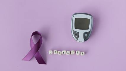 A purple awareness ribbon, a blood glucose meter, and wooden letter cubes spelling "diabetes" on a light purple background, symbolizing health awareness and disease management.