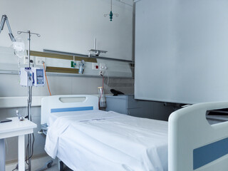 Hospital room with empty bed and medical gas, oxygen, and vacuum supply sources