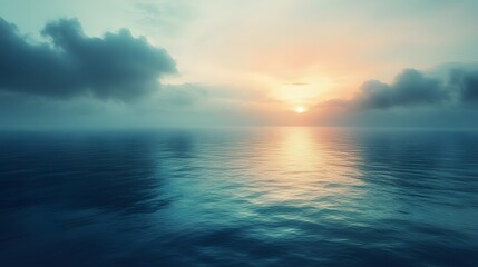 Obraz premium A breathtaking sunset over the vast ocean, with soft clouds casting a warm glow on the water's surface.