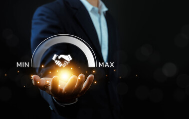 Business partnership trust concept with businessman holding glowing handshake icon and progress gauge from minimum to maximum, symbolizing strong collaboration, growth, agreement, success.