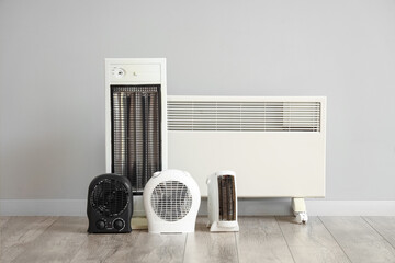 Different electric heaters near light wall