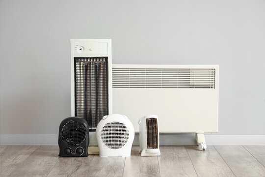 Different electric heaters near light wall