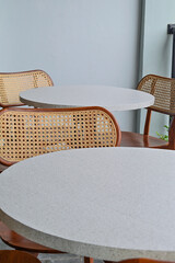 Empty table And wooden chairs, grey or gray, granite. set. outdoor seating for restaurant, Cafe or coffee shop. wall. wood. brown. white. wall. vertical. decor, decoration. elegance. out