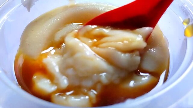 Stirring Sweet Rice Porridge with Brown Sugar Syrup Close Up