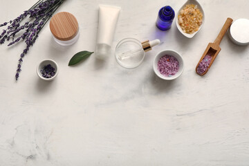 Fototapeta na wymiar Natural cosmetics with lavender flowers and sea salt on white grunge background