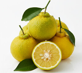 Fresh yuzu citrus fruit cut half with leaves