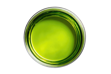 Bright green liquid in glass, top-down view