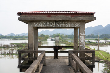 Concrete floodgate structure over river in rural Ninh Binh, Vietnam