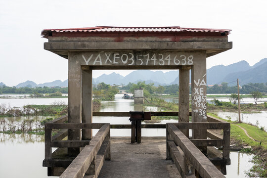 Concrete floodgate structure over river in rural Ninh Binh, Vietnam