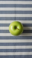 Green Resting on Blue and White Striped Fabric