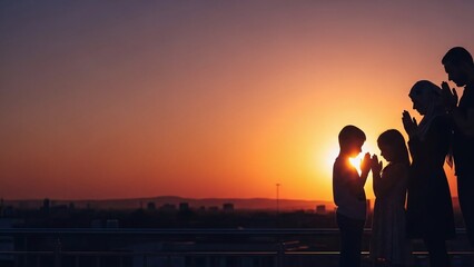 Fototapeta premium Family in prayer at sunset with hands clasped in devotion
