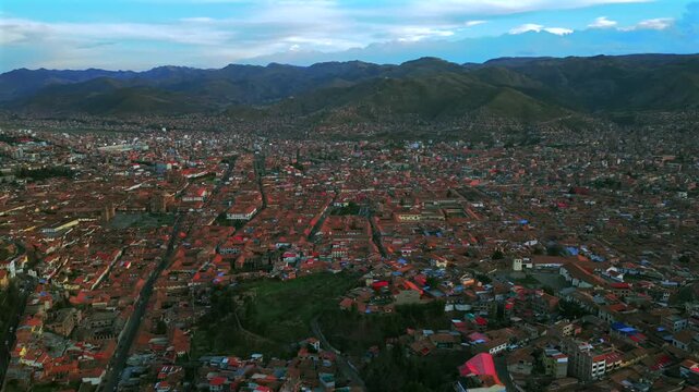 Cusco Plaza de Armas vive en Peru Per&uacute; aerial drone Cuzco October cityscape red buildings Peruvian Andes landscape rainy season sunny daytime sunset clouds Inca Empire capitol forward pan up motion