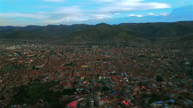 Cusco Plaza de Armas vive en Peru Per&uacute; aerial drone Cuzco October cityscape red buildings Peruvian Andes landscape rainy season sunny daytime sunset clouds Inca Empire capitol parallax circle left