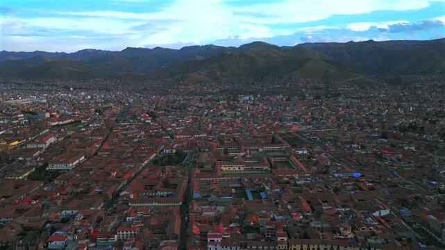 Plaza de Armas main town square vive en Peru Per&uacute; aerial drone October cityscape red buildings Peruvian Andes landscape rainy season sunny daytime sunset clouds Inca Empire capitol backwards