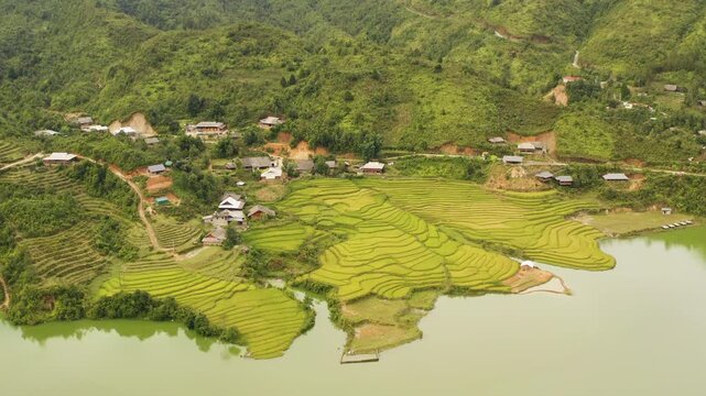 Cinematic footage of Seo My Ty, the highest lake in Vietnam. Showcasing emerald water, lush terraced fields, and rugged mountains in Hoang Lien National Park. Perfect for travel and nature projects.